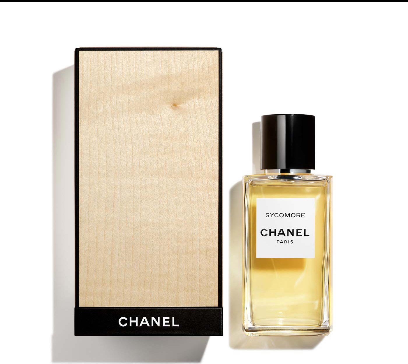 A bottle of SYCOMORE Eau de Parfum next to it's limited-edition, exclusive case